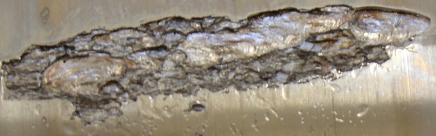 Close up of a damaged area showing a combination of fatigue and embrittlement damages